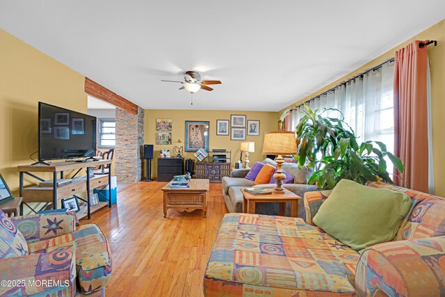 living room featuring wood finished floors and a ceiling fan