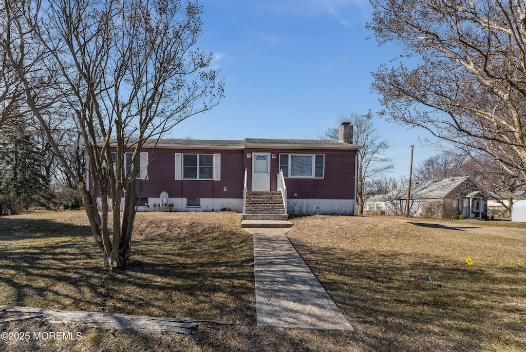 27 Kearney Rd, South Amboy, NJ 08879 - view of front of house with a chimney and a front lawn