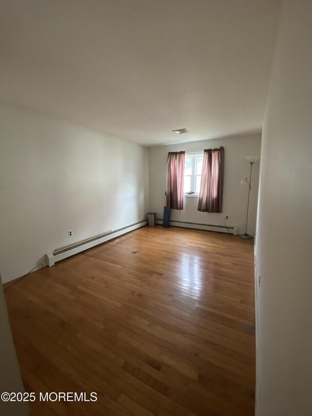 18 Arneytown Hornerstown Rd, Cream Ridge, NJ 08514 - spare room featuring a baseboard radiator and wood finished floors