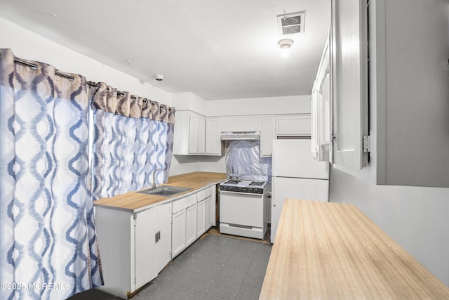 142 Coventry Dr, Lakewood, NJ 08701 - kitchen featuring white appliances, under cabinet range hood, dark floors, a sink, and visible vents