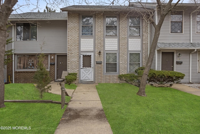 142 Coventry Dr, Lakewood, NJ 08701 - multi unit property with brick siding, roof with shingles, and a front lawn