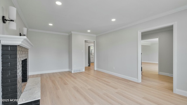 unfurnished living room with recessed lighting, visible vents, ornamental molding, light wood-type flooring, and a fireplace