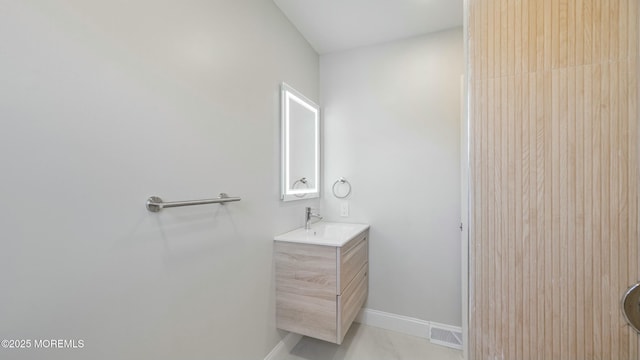 bathroom with visible vents, baseboards, and vanity