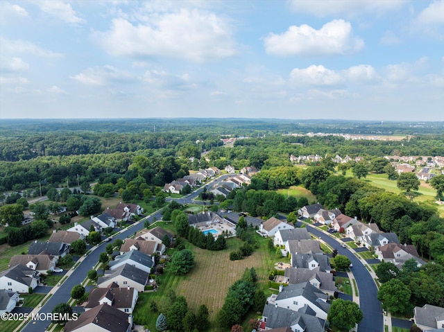 bird's eye view featuring a residential view and a wooded view