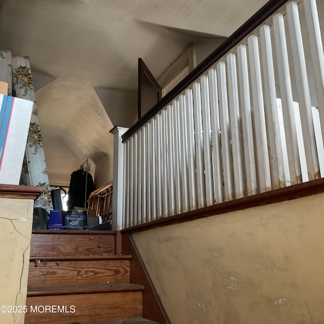 stairway featuring lofted ceiling