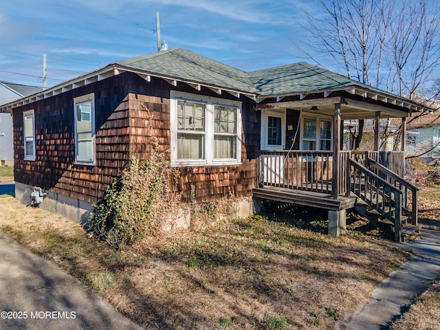 bungalow featuring a shingled roof and covered porch