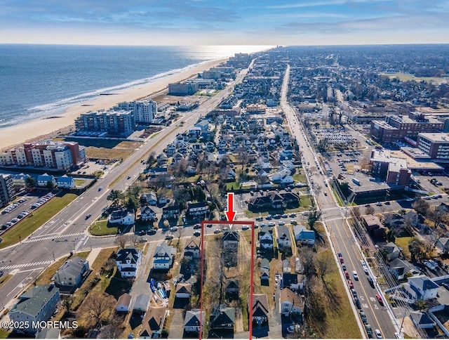 bird's eye view featuring a view of the beach and a water view