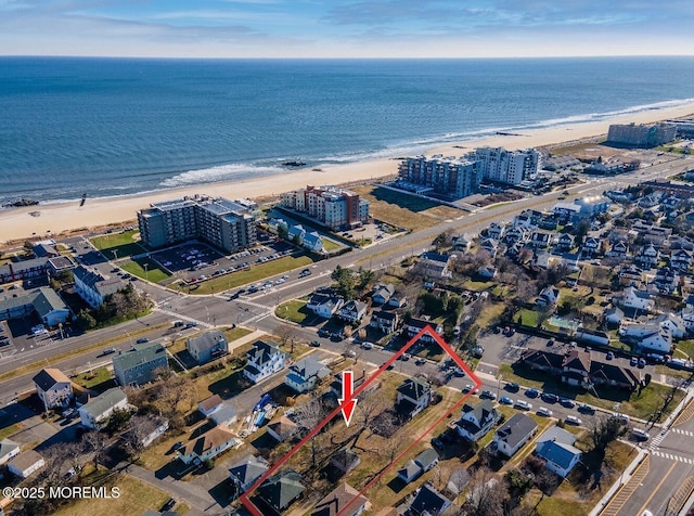 bird's eye view featuring a beach view and a water view