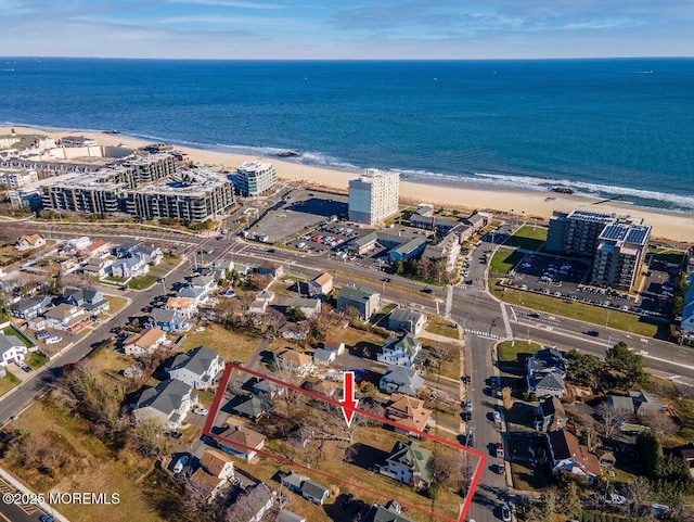 aerial view featuring a beach view, a water view, and a city view