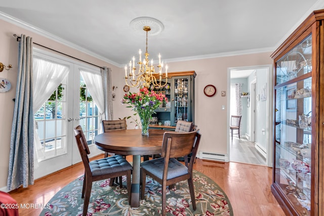 dining room with french doors, a baseboard heating unit, an inviting chandelier, and light wood-style floors