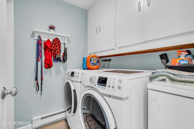 washroom with cabinet space, a baseboard heating unit, and independent washer and dryer