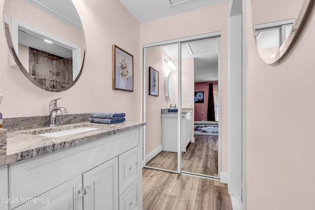 bathroom with vanity, baseboards, and wood finished floors