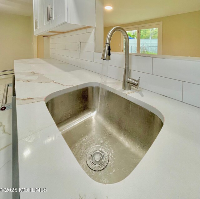 249 Center St, Little Egg Harbor, NJ 08087 - room details featuring decorative backsplash, a sink, white cabinets, and light countertops