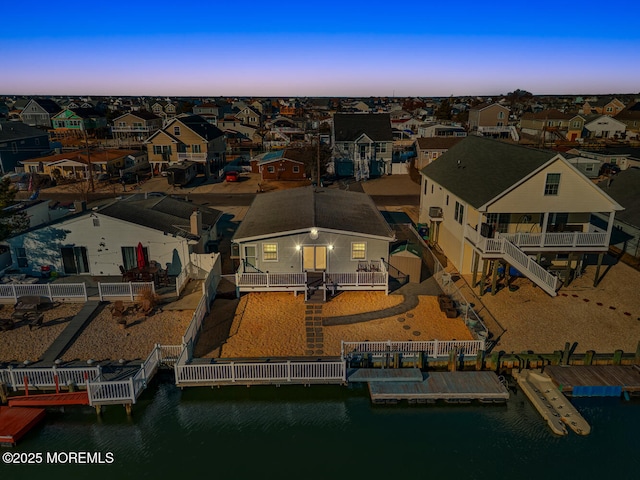 drone / aerial view with a water view and a residential view