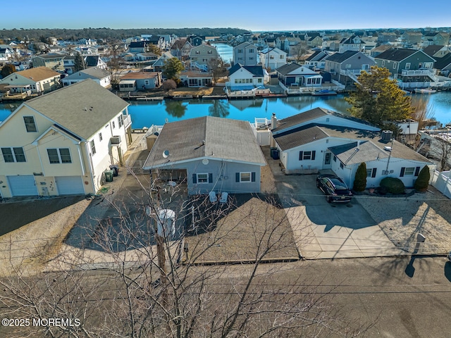 birds eye view of property featuring a water view and a residential view