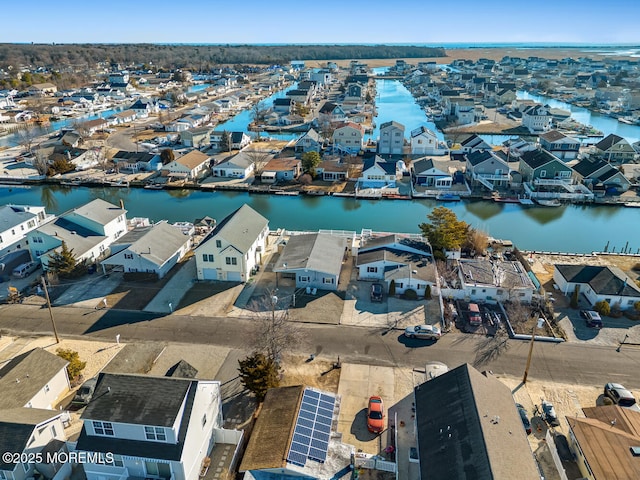 drone / aerial view featuring a water view and a residential view