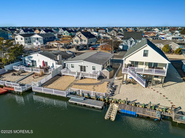 drone / aerial view with a residential view and a water view