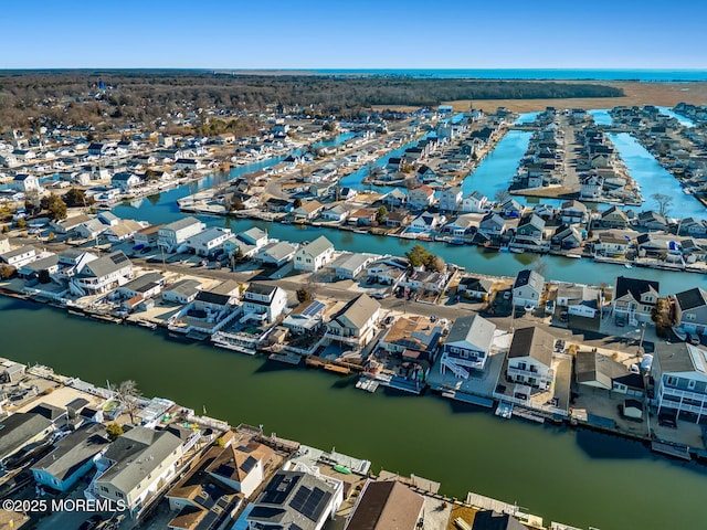drone / aerial view featuring a residential view and a water view