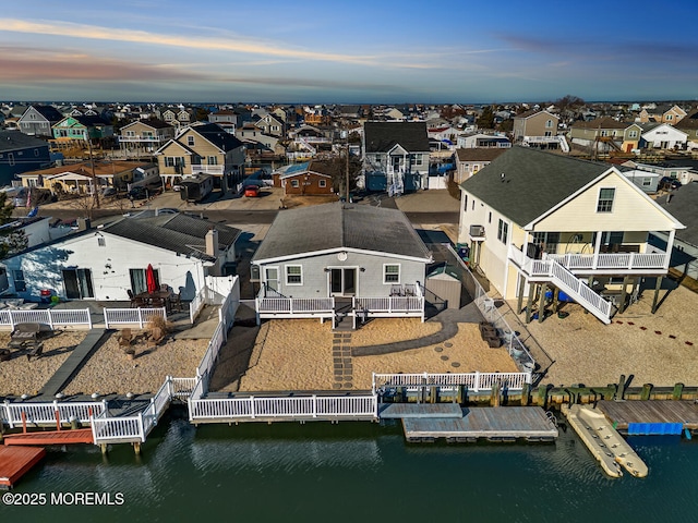 drone / aerial view with a residential view and a water view