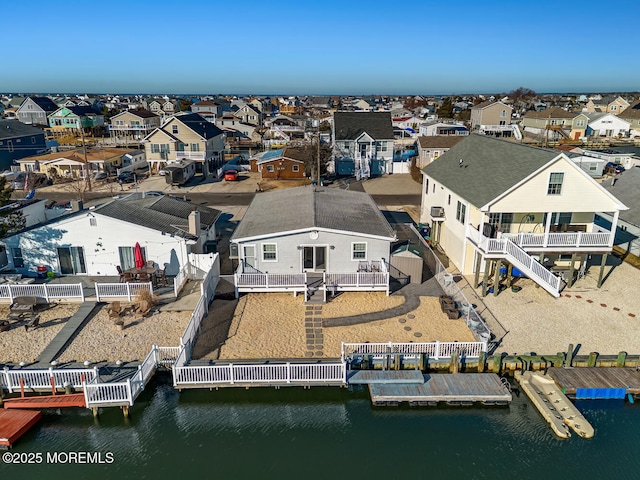 birds eye view of property with a water view and a residential view