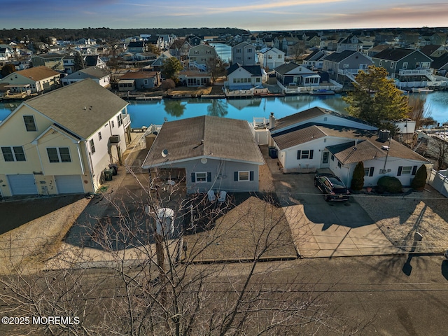 birds eye view of property with a residential view and a water view