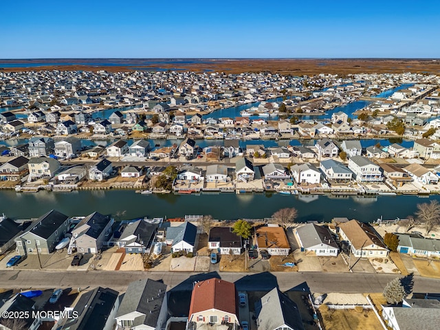 birds eye view of property with a residential view and a water view