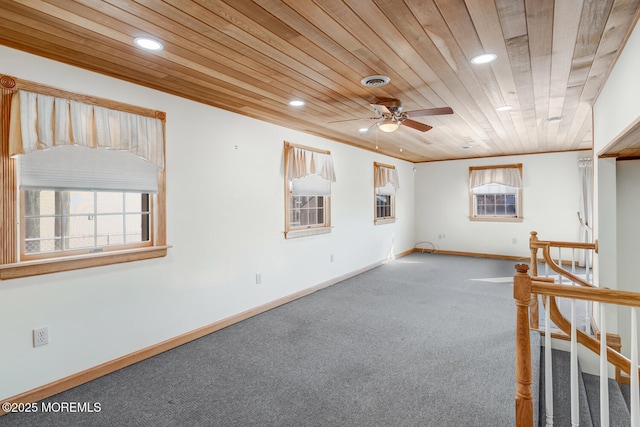 unfurnished room with visible vents, wooden ceiling, carpet floors, and a ceiling fan