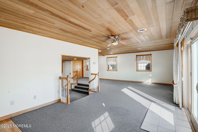 spare room featuring visible vents, baseboards, stairway, a ceiling fan, and wooden ceiling