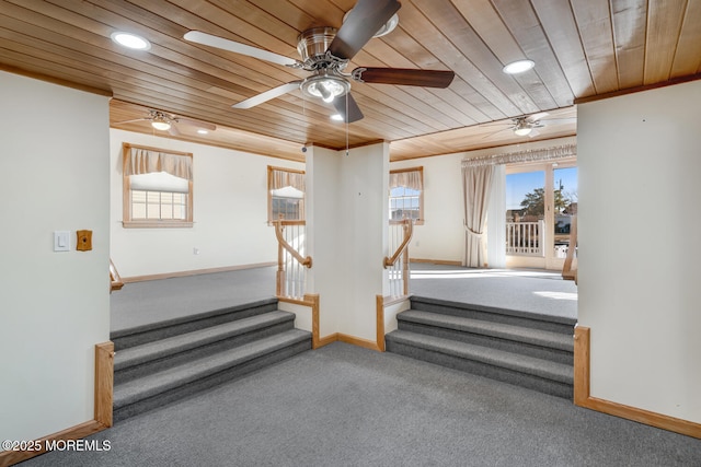 stairway featuring baseboards, carpet flooring, crown molding, and wood ceiling