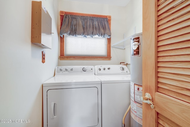 laundry area featuring water heater, washing machine and clothes dryer, and laundry area