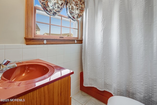full bath featuring tile walls, toilet, tile patterned floors, and vanity