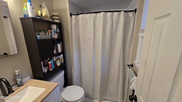 bathroom featuring a shower with shower curtain, vanity, and toilet