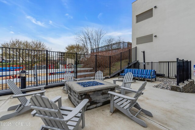 28 Riverside Ave Unit 1H, Red Bank, NJ 07701 - view of patio / terrace featuring an outdoor fire pit and fence