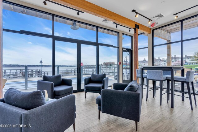 28 Riverside Ave Unit 1H, Red Bank, NJ 07701 - living area featuring plenty of natural light, a view of city, expansive windows, and visible vents