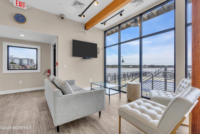 28 Riverside Ave Unit 1H, Red Bank, NJ 07701 - living area featuring baseboards, visible vents, and wood finished floors