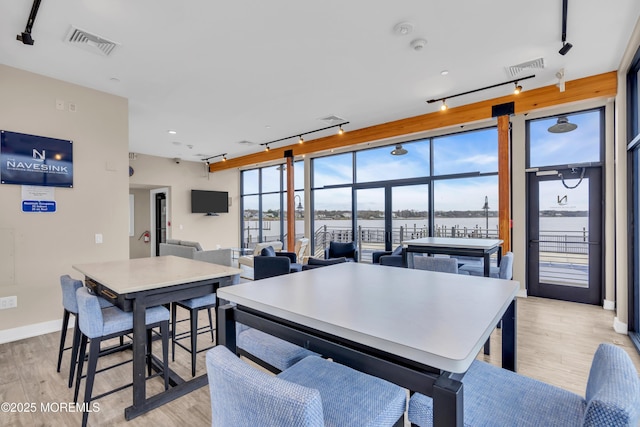 28 Riverside Ave Unit 1H, Red Bank, NJ 07701 - dining room with light wood-style flooring, track lighting, and visible vents