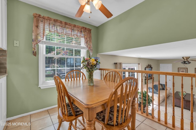dining space featuring ceiling fan, light tile patterned floors, and baseboards