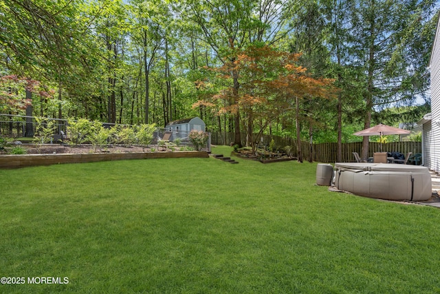 view of yard with a vegetable garden, a shed, and an outbuilding
