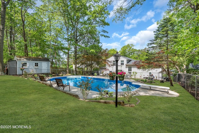 view of swimming pool with a diving board, an outdoor structure, a storage unit, and a patio area