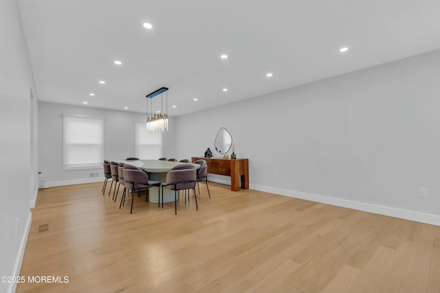 dining area featuring light wood-style flooring, baseboards, and recessed lighting