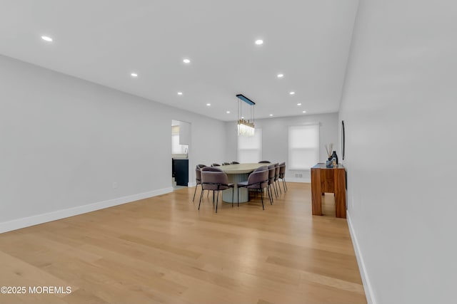 dining room with recessed lighting, light wood-style flooring, and baseboards
