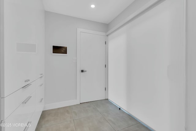 hallway featuring light tile patterned floors, recessed lighting, and baseboards
