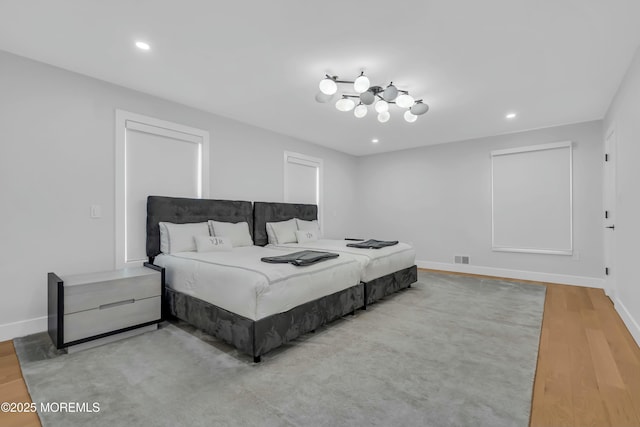 bedroom with light wood-type flooring, baseboards, and recessed lighting