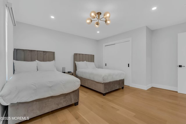 bedroom with light wood-type flooring, a chandelier, baseboards, and recessed lighting