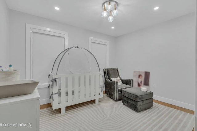 bedroom featuring baseboards, recessed lighting, and wood finished floors