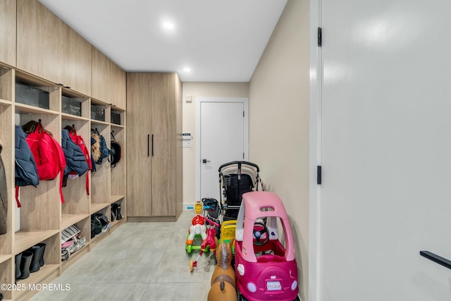 mudroom with light tile patterned floors and recessed lighting