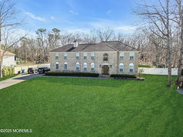 view of front of property with a chimney and concrete driveway