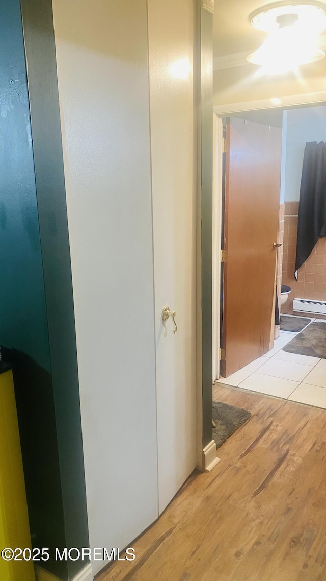 37D Cambridge Ct Unit 100D, Lakewood, NJ 08701 - hallway featuring wood finished floors and a baseboard heating unit