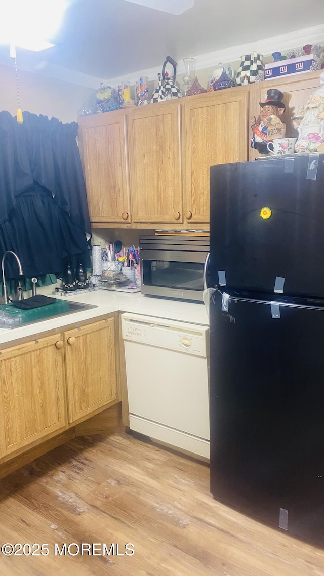 37D Cambridge Ct Unit 100D, Lakewood, NJ 08701 - kitchen with freestanding refrigerator, dishwasher, stainless steel microwave, a sink, and light wood finished floors