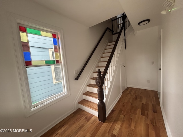 stairs with baseboards and wood finished floors